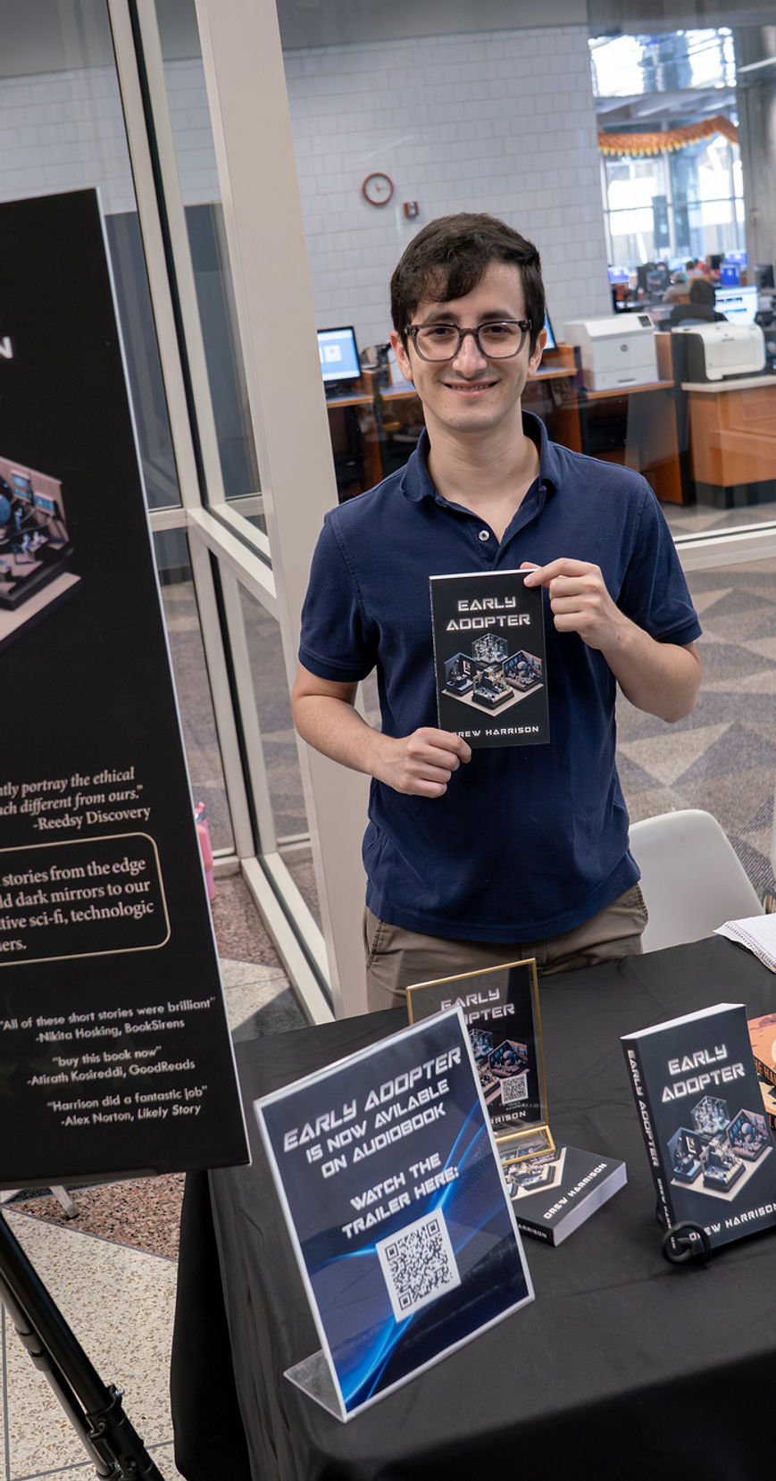 Drew Harrison holding a copy of Early Adopter